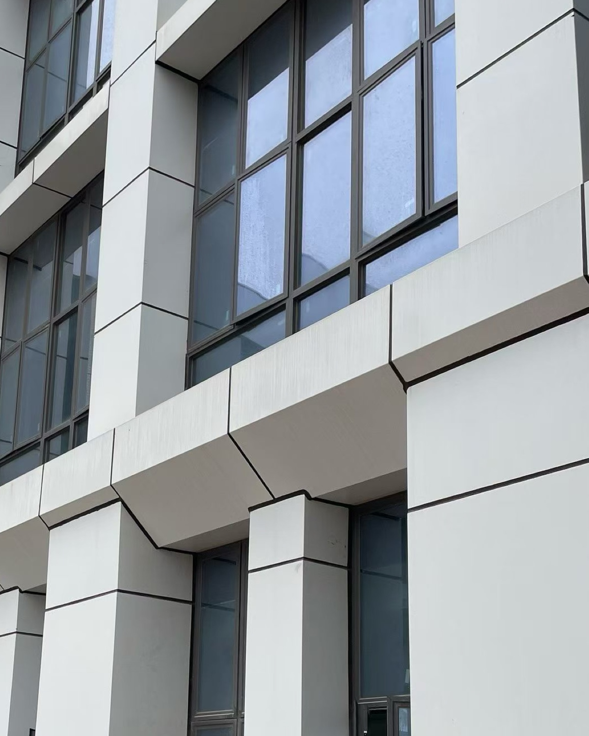 Repeated chamfered window heads, vertical reveals and panel-joint alignment in a PUNCHUK project.