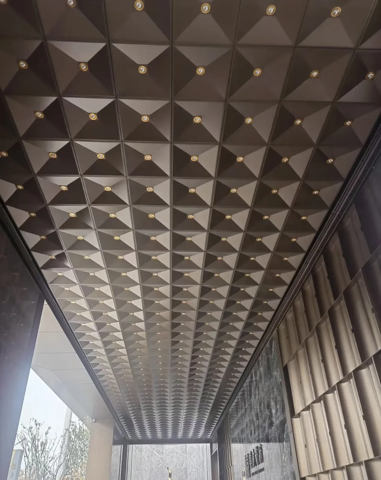 Geometric formed aluminum ceiling modules with integrated spotlights