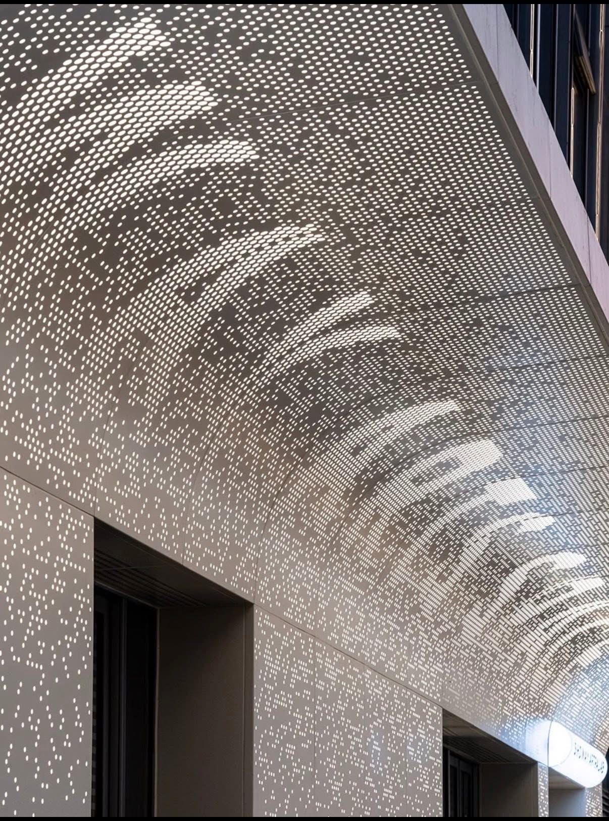 Large format curved perforated aluminum panel close up with image pattern and backlighting