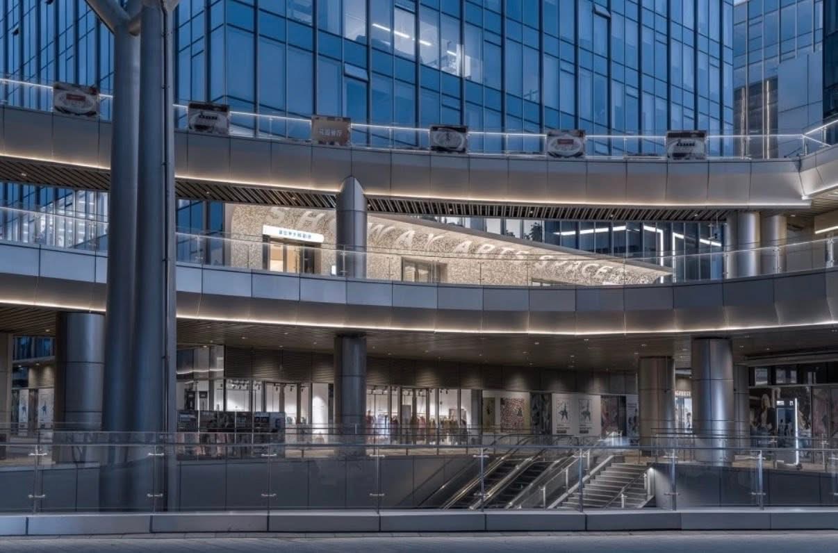 Multi-level commercial building atrium with backlit perforated aluminum facade panels