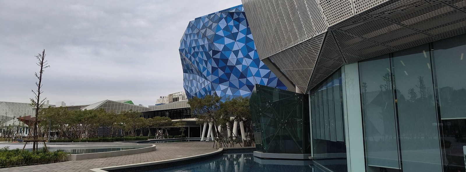 Southeast Asia geometric facade with blue aluminum cladding and perforated metal screen reference